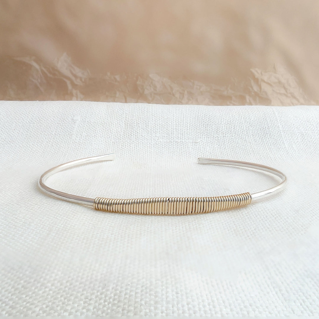 HELIX two-tone faceted cuff bracelet in sterling silver with 14K gold fill wire wrap, lying flat